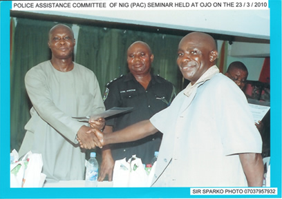 Representative of Area E Police Command, Festac shaking hands with PAC Ojo Chairman